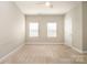 Neutral bedroom with carpet, windows, and a ceiling fan at 309 N Aspen St, Lincolnton, NC 28092
