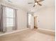 Bright bedroom with neutral carpeting, ceiling fan, and large windows allowing natural light at 309 N Aspen St, Lincolnton, NC 28092