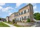 Brick townhome showcasing a front yard, black shutters, and well-maintained landscaping at 309 N Aspen St, Lincolnton, NC 28092