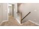 Bright hallway with carpeted stairs and white railing leading to the next level at 309 N Aspen St, Lincolnton, NC 28092