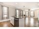 Open kitchen island overlooks the living area, with granite counters, stainless dishwasher, and sink at 309 N Aspen St, Lincolnton, NC 28092