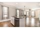 Open kitchen island overlooks the living area, with granite counters, stainless dishwasher, and sink at 309 N Aspen St, Lincolnton, NC 28092