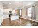Bright eat-in kitchen features granite countertops, stainless appliances, and wood-look flooring at 309 N Aspen St, Lincolnton, NC 28092