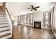 Open-concept living room with hardwood floors, fireplace, and staircase at 309 N Aspen St, Lincolnton, NC 28092