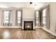 Spacious living room featuring a fireplace, hardwood floors, and natural light at 309 N Aspen St, Lincolnton, NC 28092
