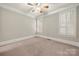 Cozy bedroom with neutral carpet, ceiling fan, white trim, and plantation shutters allowing ample natural light at 310 Ridge Reserve Dr, Clover, SC 29710