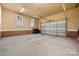 Spacious two car garage with paneled garage door and brick accents at 310 Ridge Reserve Dr, Clover, SC 29710