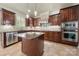Modern kitchen featuring stainless steel appliances, granite countertops, and custom cabinetry at 310 Ridge Reserve Dr, Clover, SC 29710