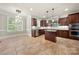 Large kitchen with granite countertops, stainless appliances, island, and hardwood tile floors at 310 Ridge Reserve Dr, Clover, SC 29710