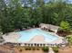 Aerial view of a neighborhood swimming pool and amenity center surrounded by lush trees at 310 Ridge Reserve Dr, Clover, SC 29710