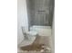 Bathroom featuring gray tiled shower, a new toilet, and a tub at 312 Wesley Heights Way # B, Charlotte, NC 28208