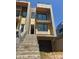 Modern two-story home featuring large windows, gray stone, and a convenient attached garage at 312 Wesley Heights Way # B, Charlotte, NC 28208