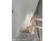 Stairwell featuring a wooden railing and white painted walls at 312 Wesley Heights Way # B, Charlotte, NC 28208