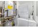 Compact laundry room featuring stacked washer and dryer, and water heater at 333 W Trade St # 1500, Charlotte, NC 28202