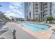 Relaxing pool with city views, lounge area, and built in grill at 333 W Trade St # 1500, Charlotte, NC 28202