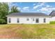 Home's backyard features lush green grass and a back exterior entrance, great for entertaining guests at 3478 Winters St, Newton, NC 28658