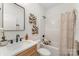 Clean bathroom features a shower-tub combo, with white toilet and brown wooden accents at 3478 Winters St, Newton, NC 28658