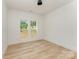 Bright bedroom with ample natural light shining through two windows and wooden flooring at 3478 Winters St, Newton, NC 28658