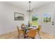 Cozy dining room with a modern chandelier, round table with seating for four, and a large window with a view of the backyard at 3478 Winters St, Newton, NC 28658