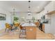 Well-lit open kitchen and dining area featuring stainless steel appliances, an island with seating, and hardwood floors at 3478 Winters St, Newton, NC 28658