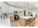 Modern kitchen featuring stainless steel appliances, white cabinets, an island with seating and pendant lights, and hardwood floors at 3478 Winters St, Newton, NC 28658