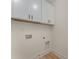 Bright laundry room ready for install with white shaker cabinets, and hookups for washer and dryer at 3478 Winters St, Newton, NC 28658