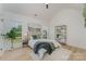 Serene bedroom with high ceilings, paneling, hardwood floors, large windows, and modern decor at 3478 Winters St, Newton, NC 28658