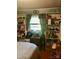 Bedroom featuring decorative curtains, built in shelving, and hardwood flooring at 3715 Vanderburg Dr, Concord, NC 28025