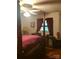Bedroom featuring a four-poster bed and a large window covered in decorative burgundy curtains at 3715 Vanderburg Dr, Concord, NC 28025