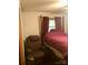 Cozy bedroom with upholstered chair, matching drapes, and four-poster bed at 3715 Vanderburg Dr, Concord, NC 28025