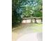 Three car garage near lush trees being mowed at 3715 Vanderburg Dr, Concord, NC 28025