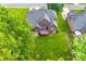 Aerial view of a brick home with mature trees, a manicured lawn, and a deck at 3741 Tea Olive Rd, Gastonia, NC 28056