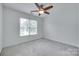 Bright bedroom with neutral carpet, ceiling fan, and window at 3741 Tea Olive Rd, Gastonia, NC 28056