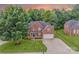 Brick two-story home with mature trees and well-manicured lawn at 3741 Tea Olive Rd, Gastonia, NC 28056