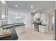 Bright kitchen with white cabinets, black countertops, stainless steel appliances, and hardwood floors at 3741 Tea Olive Rd, Gastonia, NC 28056