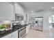 Modern kitchen with white cabinets, stainless steel appliances, and a breakfast nook at 3741 Tea Olive Rd, Gastonia, NC 28056