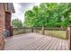 Wood deck with decorative railing and view of mature trees at 3741 Tea Olive Rd, Gastonia, NC 28056