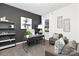 Stylish home office with dark gray accent wall, modern furnishings, and ample natural light at 3940 Ashton Nw Dr, Conover, NC 28613
