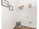 Clean laundry room featuring overhead shelving, washer/dryer hookups, and stylish decor at 3940 Ashton Nw Dr, Conover, NC 28613