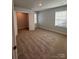 Spacious bedroom with carpeted floors, two windows, and a walk-in closet at 4029 Port Richmond Ave # 6, Gastonia, NC 28056