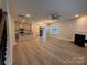 Spacious living room with hardwood floors, a cozy fireplace, and open access to the kitchen and entryway at 4029 Port Richmond Ave # 6, Gastonia, NC 28056
