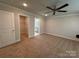 Spacious main bedroom features plush carpeting, a ceiling fan, and adjoining walk-in closet and bathroom at 4029 Port Richmond Ave # 6, Gastonia, NC 28056