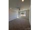 Bright bedroom featuring a ceiling fan, neutral walls, plush carpeting, and a large window with natural light at 4037 Port Richmond Ave # 8, Gastonia, NC 28056