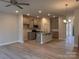 Bright kitchen and living space featuring stainless appliances, gray cabinets, and hardwood floors at 4037 Port Richmond Ave # 8, Gastonia, NC 28056