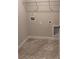 A laundry room with gray marble floors, a laundry hook-up, white walls and base trim at 4037 Port Richmond Ave # 8, Gastonia, NC 28056