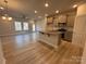 Open concept living space with modern kitchen, stainless steel appliances, and hardwood floors at 4037 Port Richmond Ave # 8, Gastonia, NC 28056