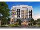 Elegant condo building with balconies, stone accents, and well-maintained landscaping showcasing luxury living at 409 Queens Rd # 202, Charlotte, NC 28207
