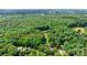 An aerial view showcases vast acreage and the home's position surrounded by a border of green foliage at 4916 Leepers Creek Rd, Maiden, NC 28650