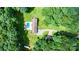 Bird's eye view showcases a red brick house with a pool, long driveway, and lush surroundings at 4916 Leepers Creek Rd, Maiden, NC 28650