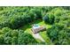 Expansive aerial view of estate home surrounded by lush greenery, pool, and a long driveway at 4916 Leepers Creek Rd, Maiden, NC 28650